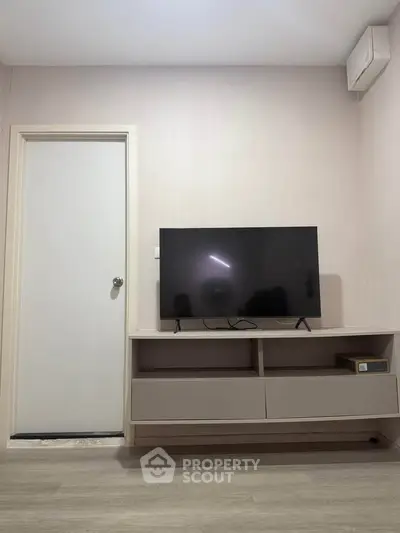Modern living room with sleek TV stand and flat-screen TV, minimalist design