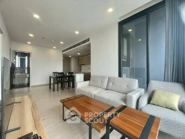 Spacious modern living room with elegant furniture and open kitchen layout