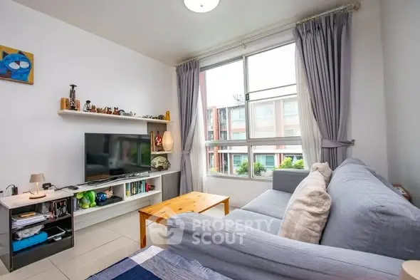 Bright and cozy living room with large window and modern decor