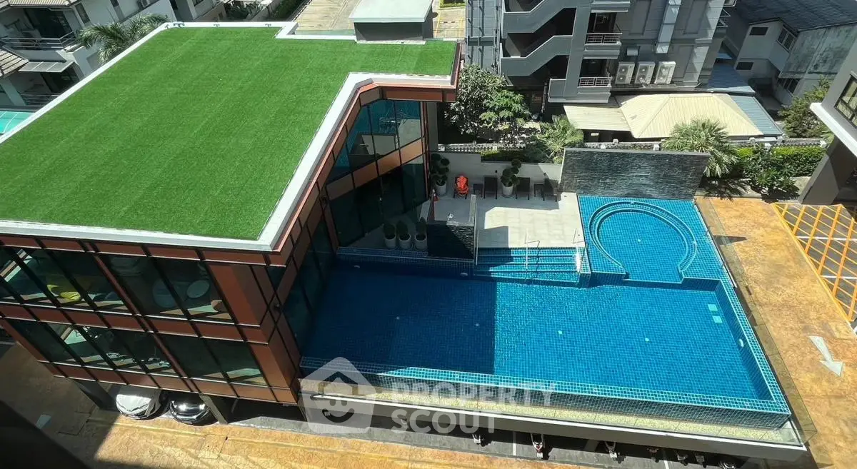 Luxurious rooftop pool with modern architecture and lush greenery, perfect for relaxation and entertainment.