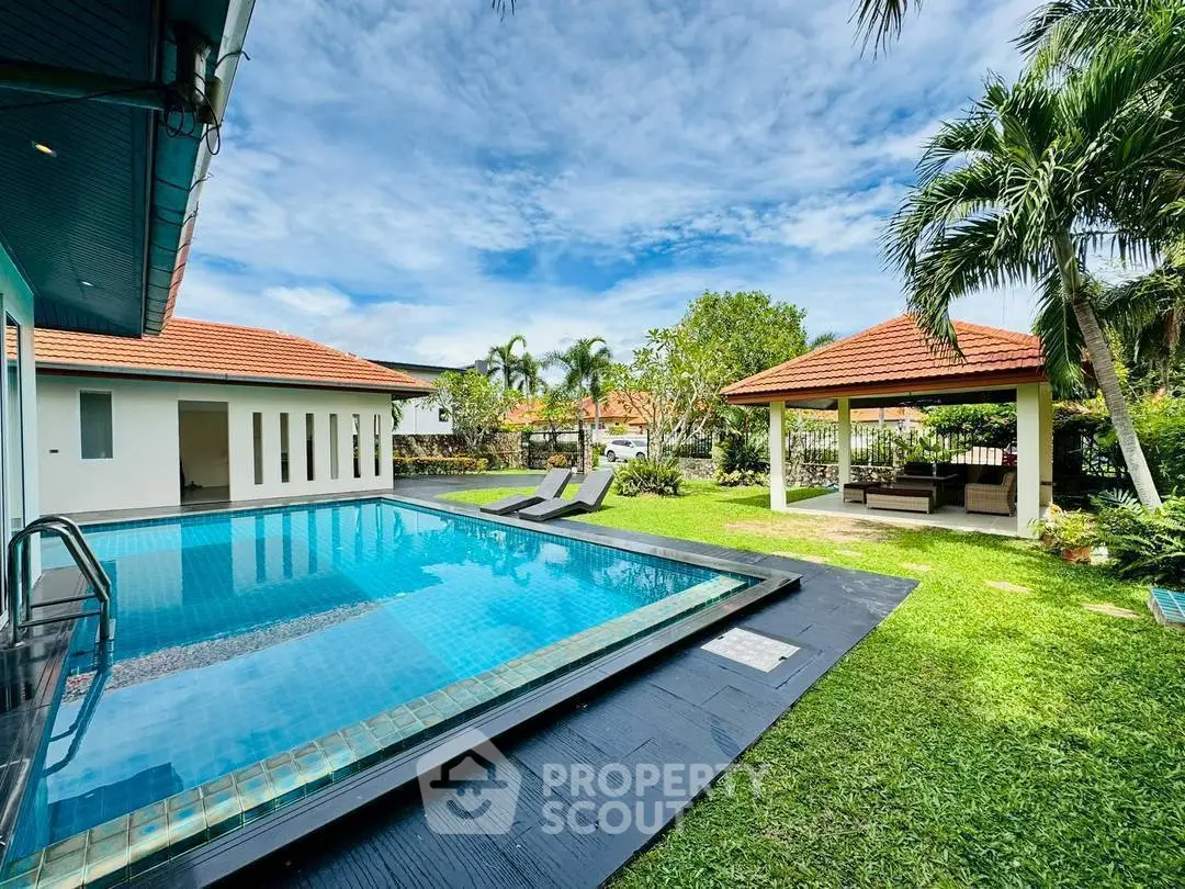 Luxurious villa with private pool and lush garden, perfect for tropical living.