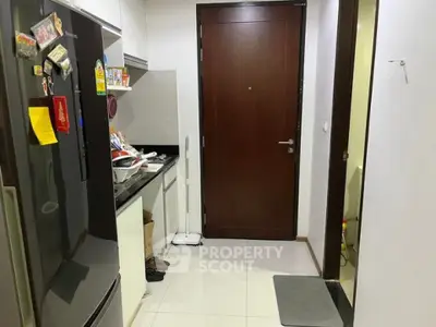 Modern kitchen entrance with sleek appliances and stylish decor