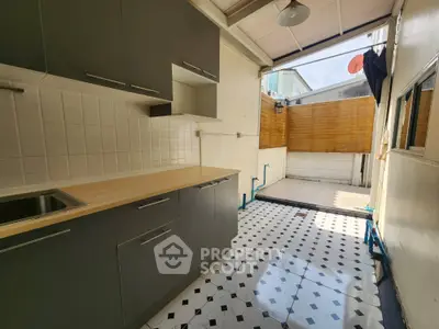 Modern kitchen with open layout and stylish black and white flooring