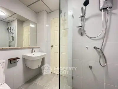 Modern bathroom with sleek fixtures and spacious shower area.