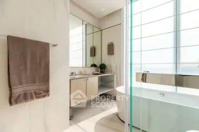 Luxurious bathroom with modern design and elegant bathtub in bright natural light.