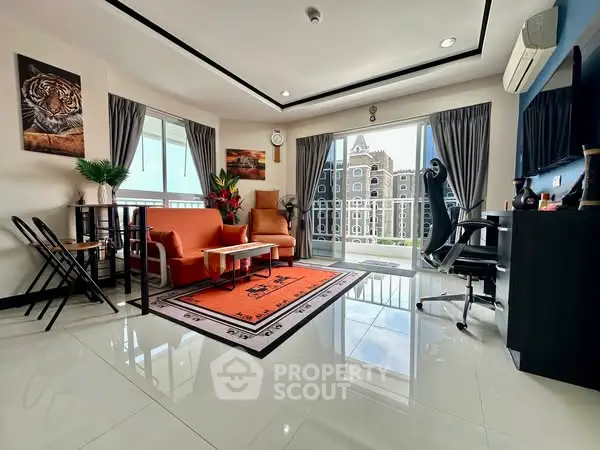 Spacious living room with modern decor and balcony view, perfect for relaxation and entertaining.