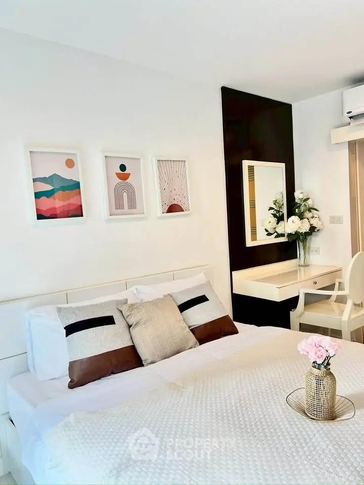 Modern bedroom with stylish decor and cozy ambiance, featuring a comfortable bed and elegant artwork.