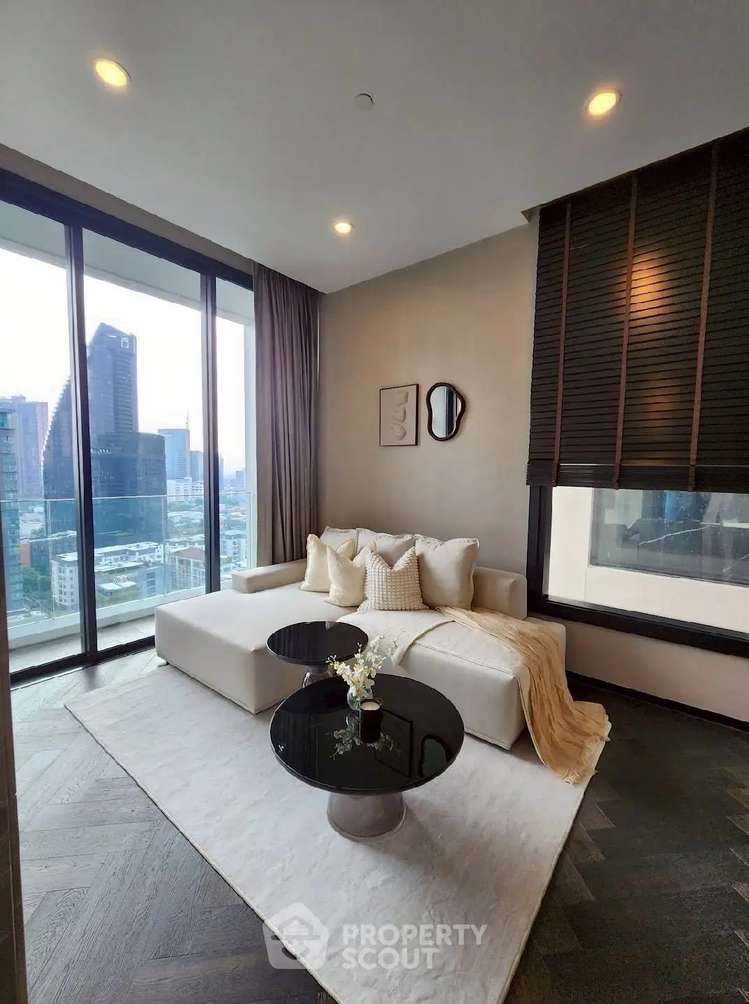 Luxurious living room with stunning city view, elegant decor, and floor-to-ceiling windows in modern apartment.