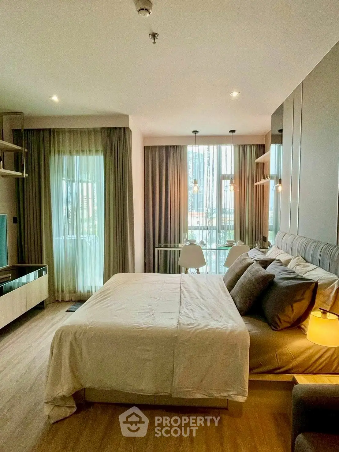 Modern bedroom with large windows and stylish decor in a luxury apartment