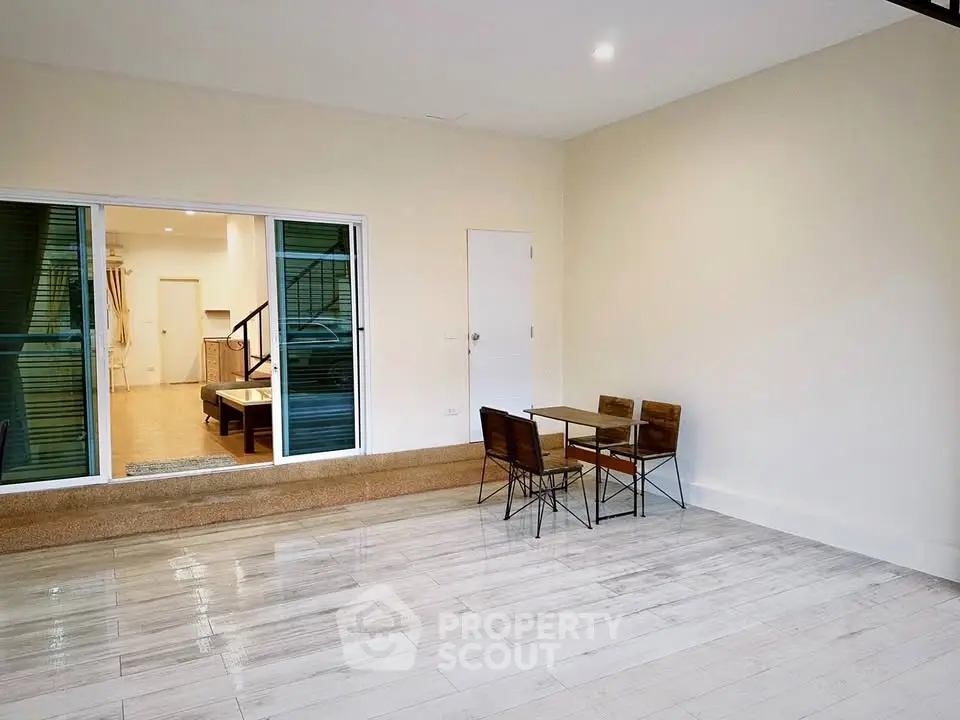 Spacious modern living area with sleek flooring and stylish dining set