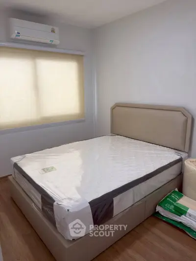 Cozy bedroom with natural light and modern air conditioning unit