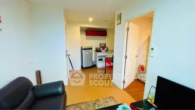 Cozy apartment interior with modern kitchen and living area, featuring sleek appliances and stylish decor.