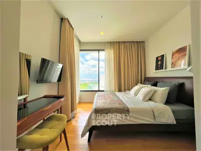 Modern bedroom with large window offering stunning city view, featuring elegant decor and cozy ambiance.