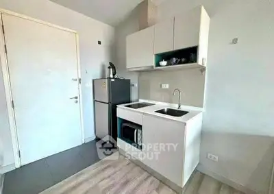 Modern compact kitchen with sleek cabinetry and built-in appliances