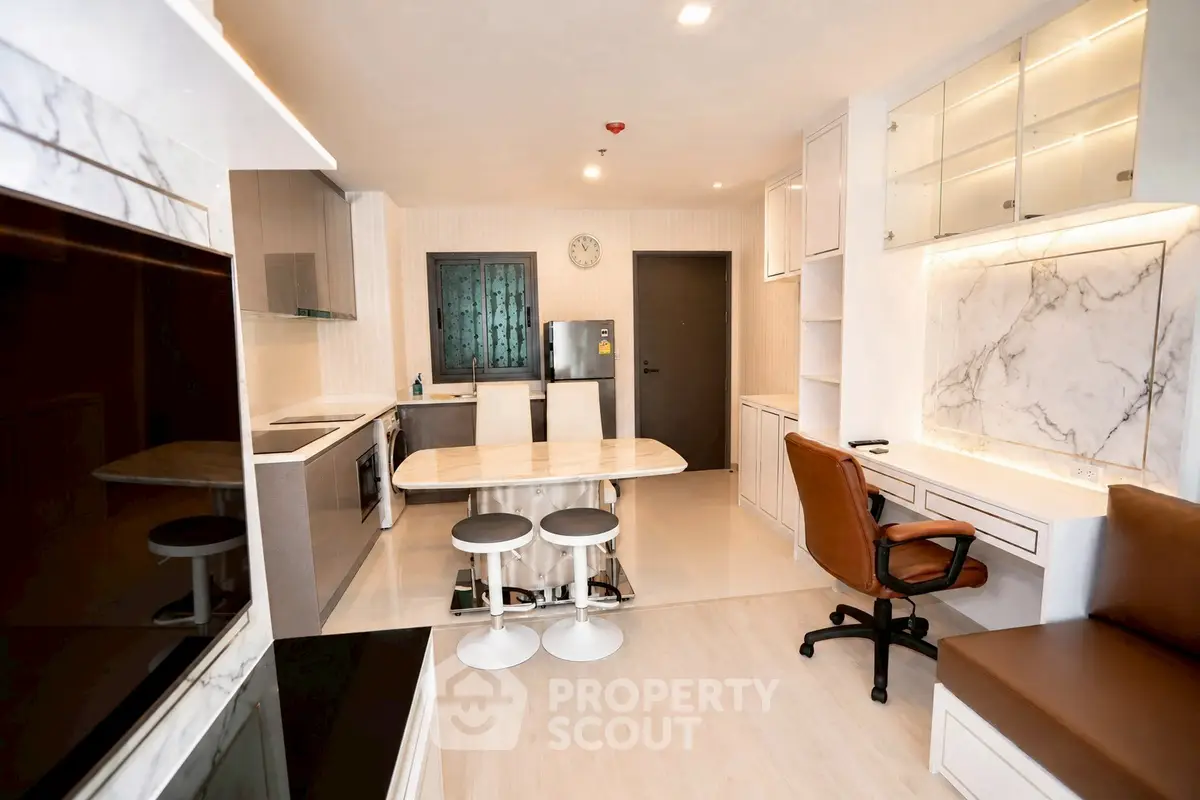 Modern kitchen with marble countertops and sleek cabinetry in a stylish apartment.