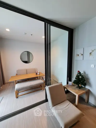 Modern living room with stylish furniture and festive decor in a cozy apartment setting.