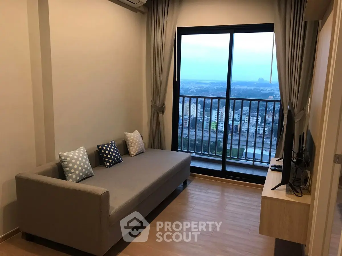 Cozy living room with balcony offering stunning city view