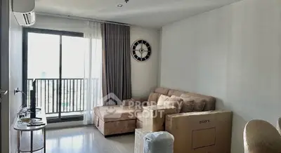 Modern living room with large window and stylish furniture, perfect for urban living.