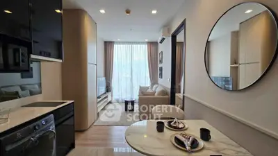 Modern apartment interior with open kitchen and cozy living room, featuring stylish decor and natural light.