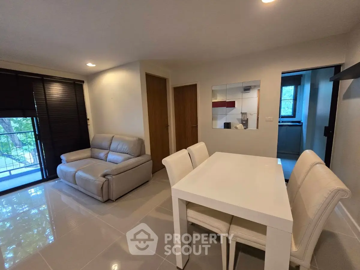 Modern living room with sleek dining area and cozy seating, perfect for urban living.