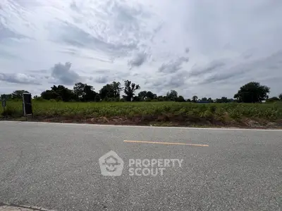 Expansive plot of land with lush greenery and clear skies, perfect for development opportunities.