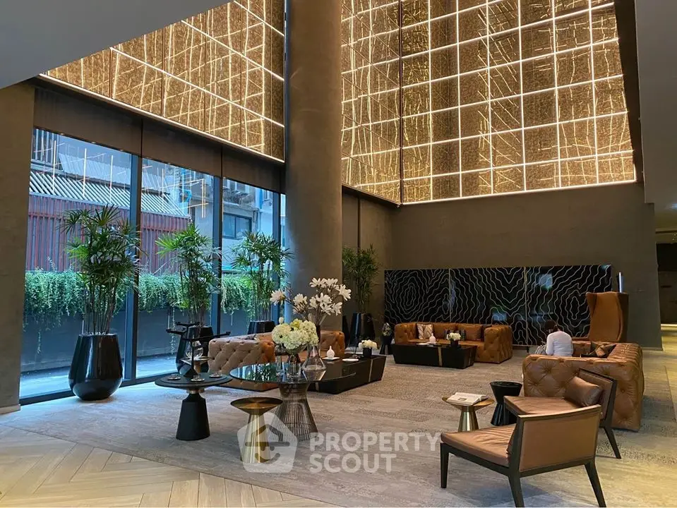 Luxurious modern living room with high ceilings and elegant lighting in a sophisticated apartment.