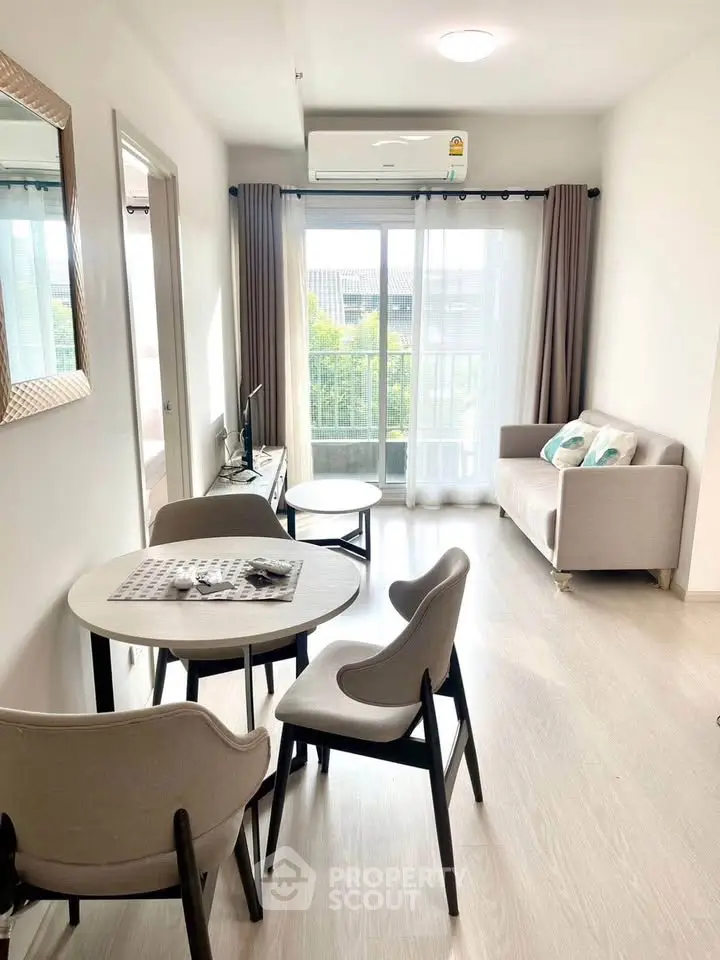 Bright and modern living room with stylish furniture and large window view.