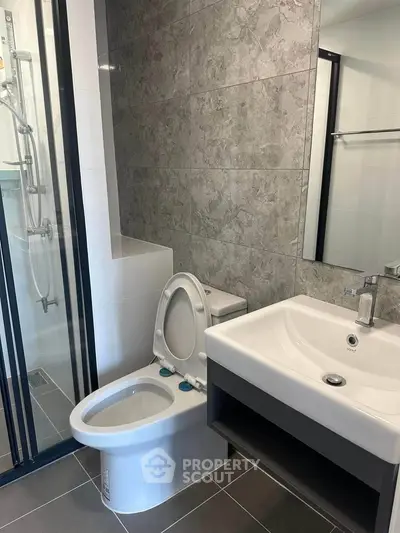 Modern bathroom with sleek fixtures and glass shower enclosure