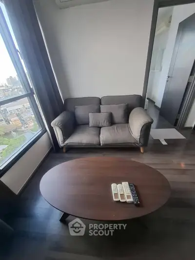 Modern living room with cozy sofa and city view, perfect for urban living.