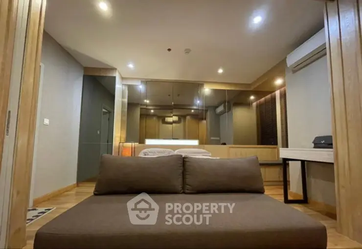 Modern living room with stylish furniture and ambient lighting in a contemporary apartment.