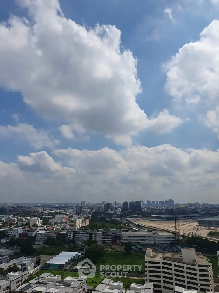 Stunning cityscape view with blue skies and clouds from a high vantage point.