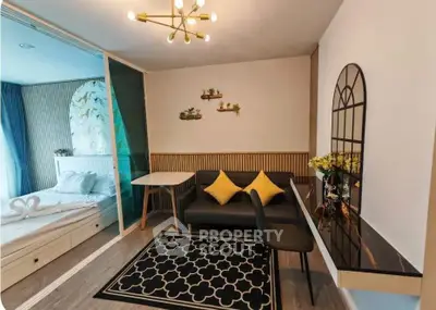 Stylish modern living room with cozy seating and elegant decor adjacent to a bright bedroom.