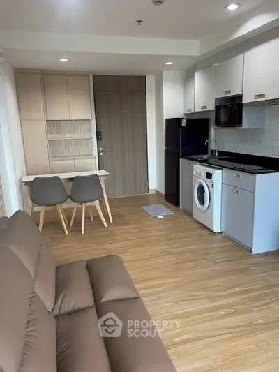 Modern apartment interior with open kitchen and cozy living area