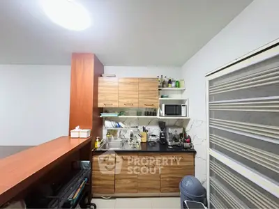 Modern kitchen with wooden cabinets and sleek appliances in a cozy open layout