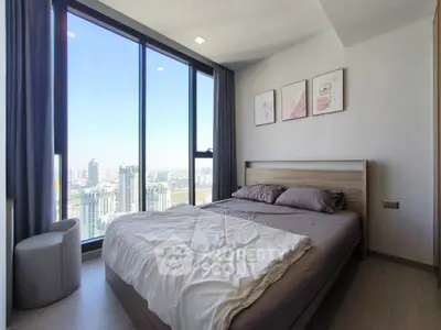 Modern bedroom with large window offering stunning city view