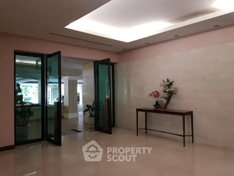 Elegant building entrance with glass doors and modern decor