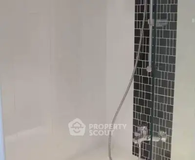 Modern bathroom shower with sleek black and white tile design