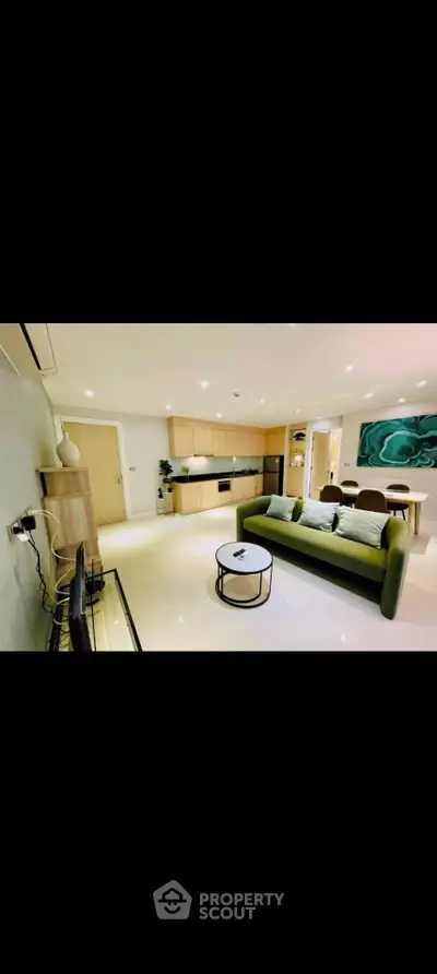 Modern open-plan living room with sleek kitchen and stylish decor