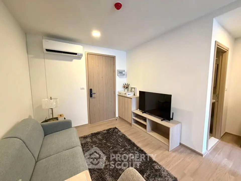 Modern living room with sleek furniture and air conditioning, perfect for cozy relaxation.