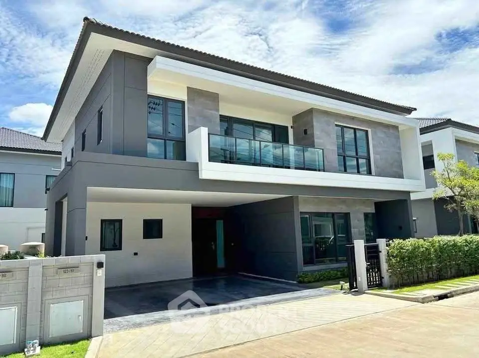 Modern two-story house with sleek design and spacious driveway in a serene neighborhood.