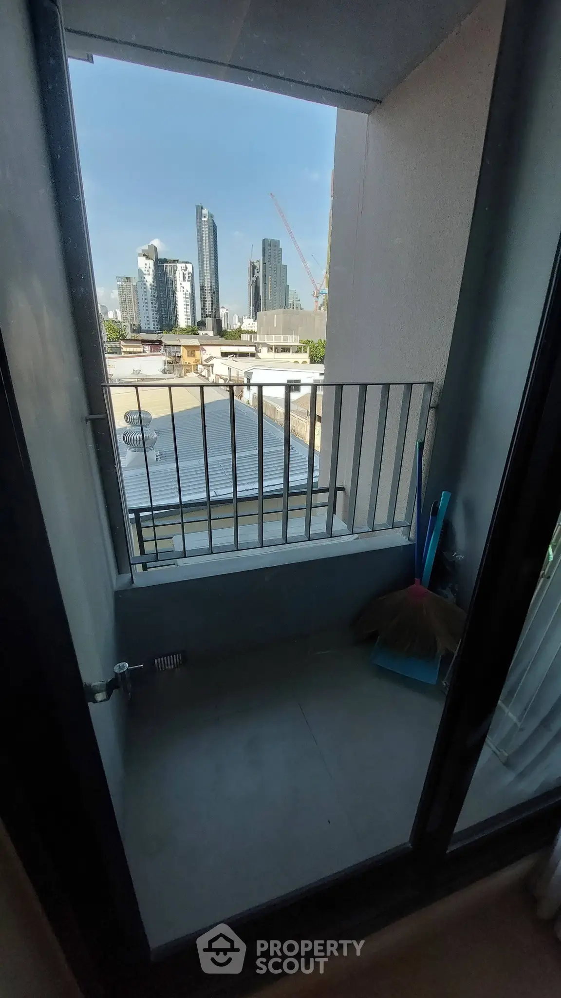 Compact balcony with cityscape view, ideal for urban living.