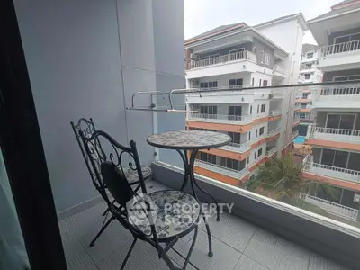 Charming balcony with stylish furniture and city view, perfect for relaxing and enjoying the outdoors.