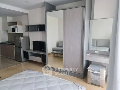 Modern studio apartment with sleek kitchen and stylish furnishings