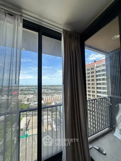 Stunning high-rise balcony view with cityscape and ocean horizon, perfect for urban living enthusiasts.