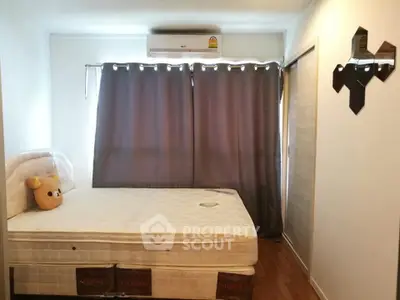 Cozy bedroom with plush mattress and modern decor in a serene apartment setting.