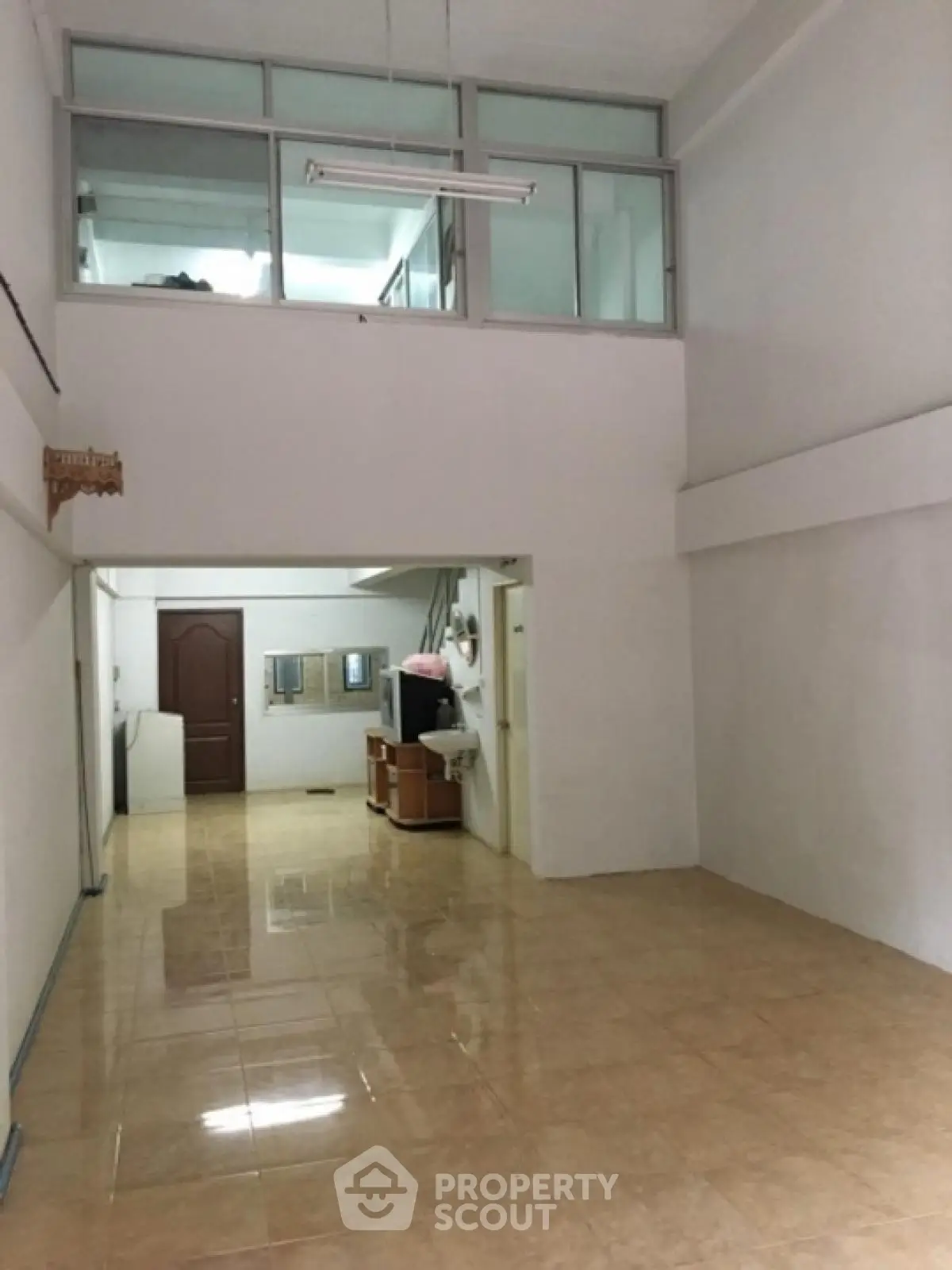 Spacious open-plan interior with high ceilings and mezzanine level
