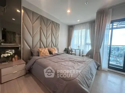 Luxurious bedroom with modern decor and city view balcony, perfect for urban living.
