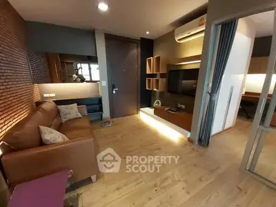 Modern living room with leather sofa and wooden flooring in stylish apartment