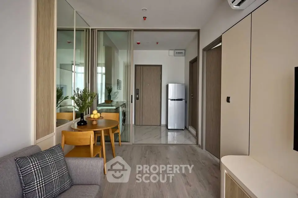 Modern living room with sleek design and compact kitchen area