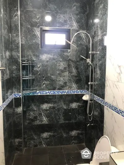 Luxurious marble bathroom with modern shower and elegant tile accents